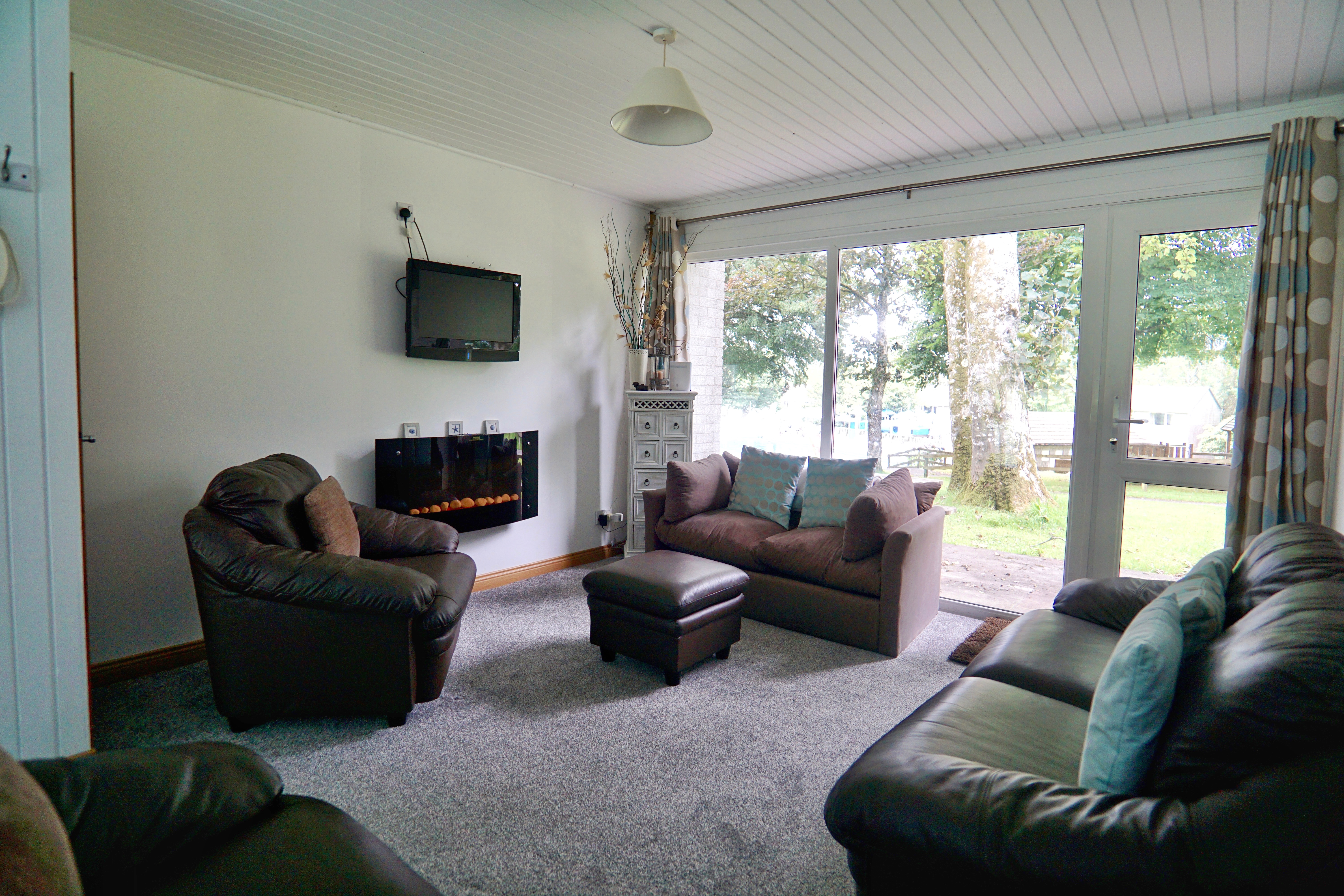 Recently, I photographed a lovely two-bedroom holiday home at Atlantic Reach Resort, a popular holiday park located just outside Newquay. Designed perfectly for couples or young families, the property offered a relaxed and practical base for exploring Cornwall, while still being close enough to enjoy the beaches and town within around fifteen minutes by car.

A Bright and Practical Holiday Home

The property itself was set up ideally for a family of four, with one double bedroom alongside a second bedroom containing two single beds. Downstairs featured an open-plan lounge and kitchenette area, creating a sociable space where families could relax together after a day exploring the coast.

One of the strongest features of the property was the amount of natural light coming into the living space. Large windows at both the front and rear helped brighten the room throughout the day, while also giving views across different parts of the site.

Views Across the Pool and Play Area

To the rear, the property overlooked the children’s play park and site swimming pool, which immediately added to its appeal as a family-friendly holiday let. From a photography perspective, these views helped give context to the location and showed potential guests exactly what was nearby.

At the front, the property overlooked the parking area, making access easy and convenient for families arriving with luggage, beach equipment or young children.

A Relaxed Base Near the Cornish Coast

Atlantic Reach Resort is made up of multiple holiday homes within a well-maintained setting, giving it a relaxed and welcoming atmosphere. Its location works particularly well for visitors wanting easy access to Newquay’s beaches, restaurants and attractions without being directly in the centre of town.

For holiday let owners, professional photography plays a huge role in helping properties stand out online, especially in busy coastal areas like Cornwall where guests are comparing large numbers of listings.

Showcasing Space and Lifestyle

When photographing holiday accommodation, the aim is always to show more than just the rooms themselves. Good imagery should help guests picture their stay before they even arrive, whether that is relaxing in the lounge after a beach day or watching children play from the rear windows.

This Atlantic Reach property combined practicality, location and family-friendly surroundings, making it an ideal holiday base and a great property to photograph.
